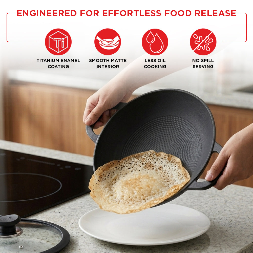 Person holding a black frying pan with a cooked pancake, kitchen setting.