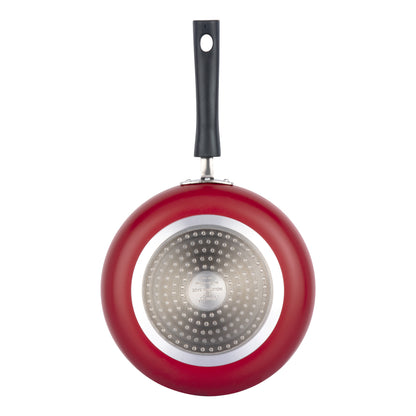 Bottom view of a red nonstick frying pan featuring an induction-compatible base and sturdy black handle.
