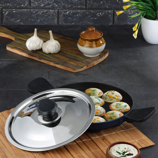 Nonstick appe pan with stainless steel lid and cooked appams, ideal for preparing healthy snacks and breakfast dishes.