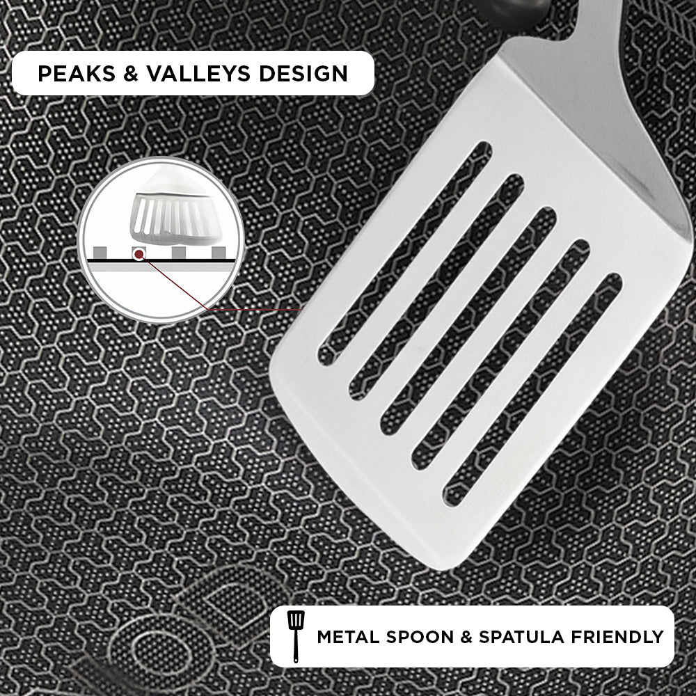 White spatula with peaks and valleys design on a textured black background