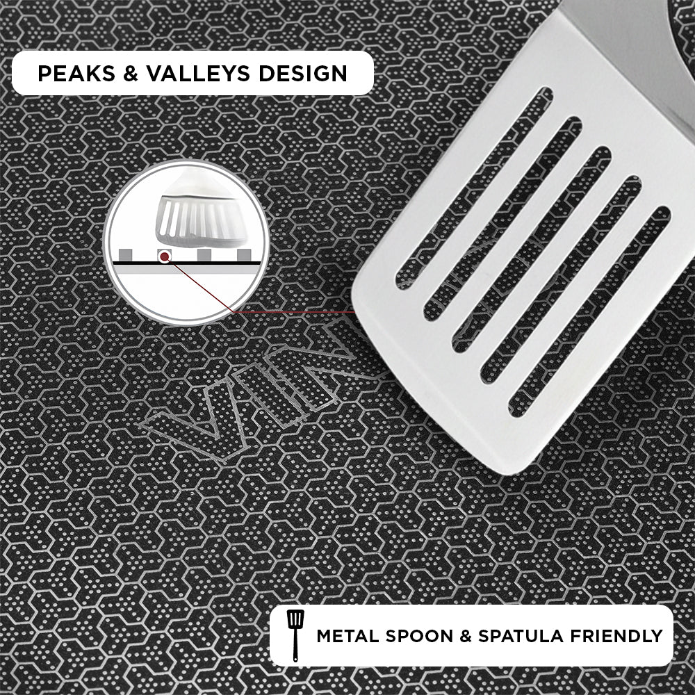 Metal spatula on a textured surface with 'Peaks & Valleys Design' text and 'Metal Spoon & Spatula Friendly' label.