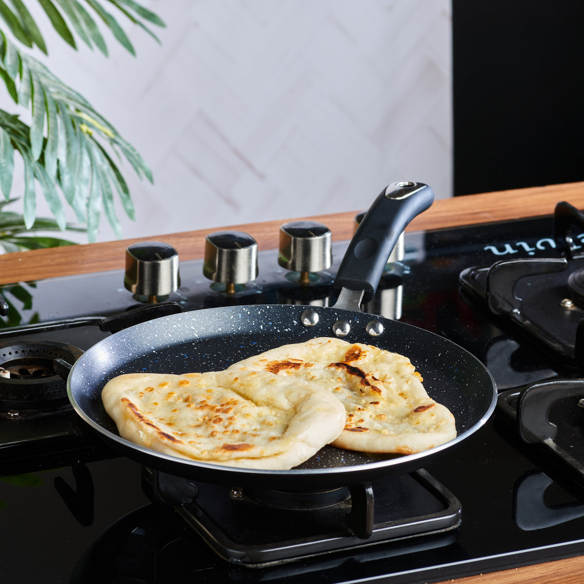 Marlibo Nonstick Dosa Tawa cooking crispy dosas on a gas stove, ideal for everyday breakfast and snack preparation.