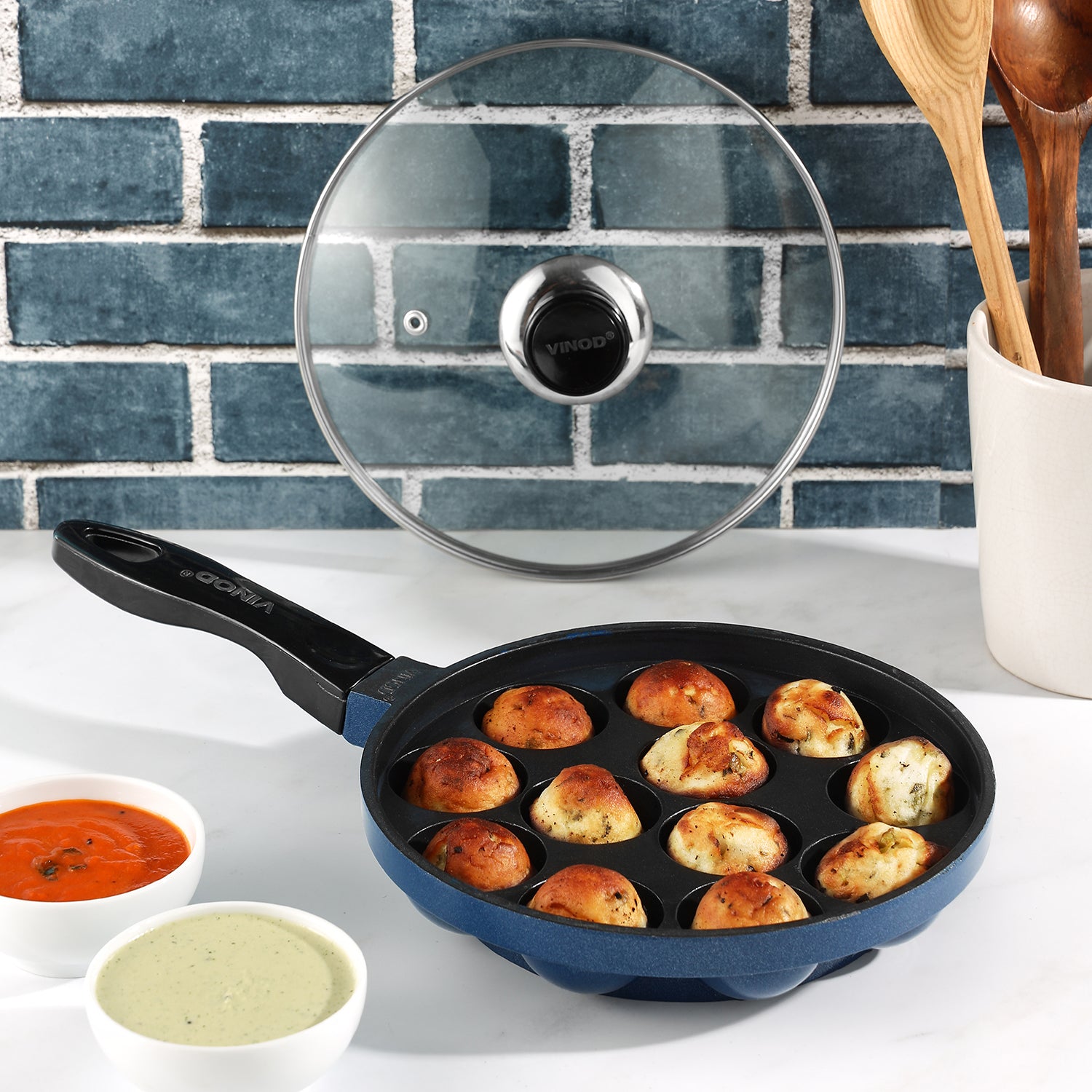 vinod Nonstick appe pan with cooked appams and a glass lid, ideal for preparing healthy snacks and breakfast dishes.