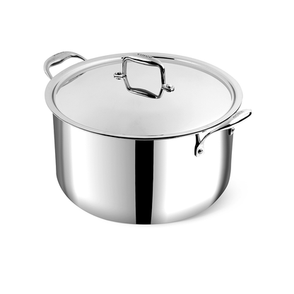 A large silver stainless steel Vinod Platinum Biryani Pot with a lid, displayed alongside a spoon and decorative spices on a kitchen towel, indicating its use for cooking biryani.